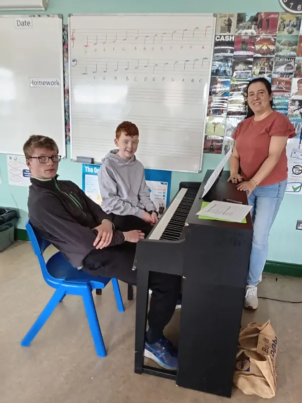 Music teacher giving a piano lesson